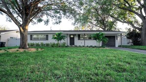 A single-story house with a front yard, a driveway, and a garage.