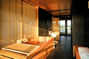 A modern bathroom with a wooden bathtub, a toilet, and a sink. - HARUNOYA (Hangzhou)