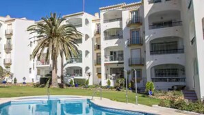 A swimming pool surrounded by multi-story buildings with balconies. - Erisa 2, 28 - Terrace, Swimming Pool, Parking, Second line of beach. 2 bedrooms (Torremolinos)