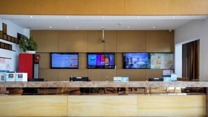 A reception area with a marble counter, multiple monitors, and a security camera. - GreenTree Inn Jiangsu Wuxi Jiangyin Yunting Changshan Avenue Chengyang Road Business Hotel (Jiangyin)