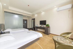 A hotel room with two beds, a desk, a TV, a chair, and a small table. - Huijia Express Hotel (Luoyang)