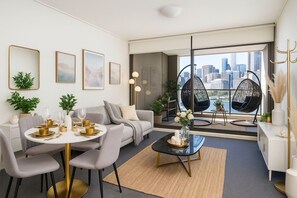 Departamento Deluxe, vista a la ciudad | Área de sala de estar