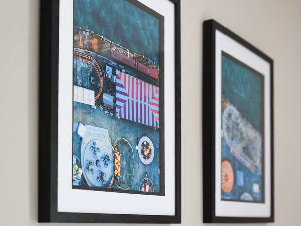 Two framed artworks on a wall.