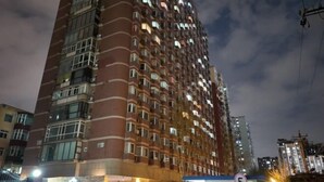 A high-rise building with multiple floors, balconies, and a well-lit entrance area. - Beijing Champs-Elysees Hotel (Panjiayuan Shilihe Subway Station) (Beijing)