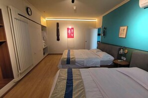 A hotel room with two beds, a bedside table, a wardrobe, a clock, and a red sign on the wall. - Beijing Champs-Elysees Hotel (Panjiayuan Shilihe Subway Station) (Beijing)
