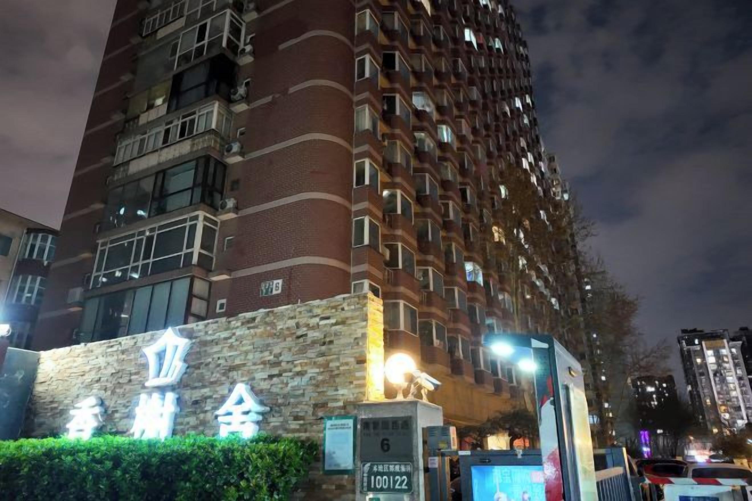 A high-rise building with a stone facade and multiple windows.