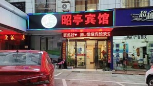 Un hôtel reconnaissable à son grand panneau rouge, à sa façade en verre et à son entrée bien visible.