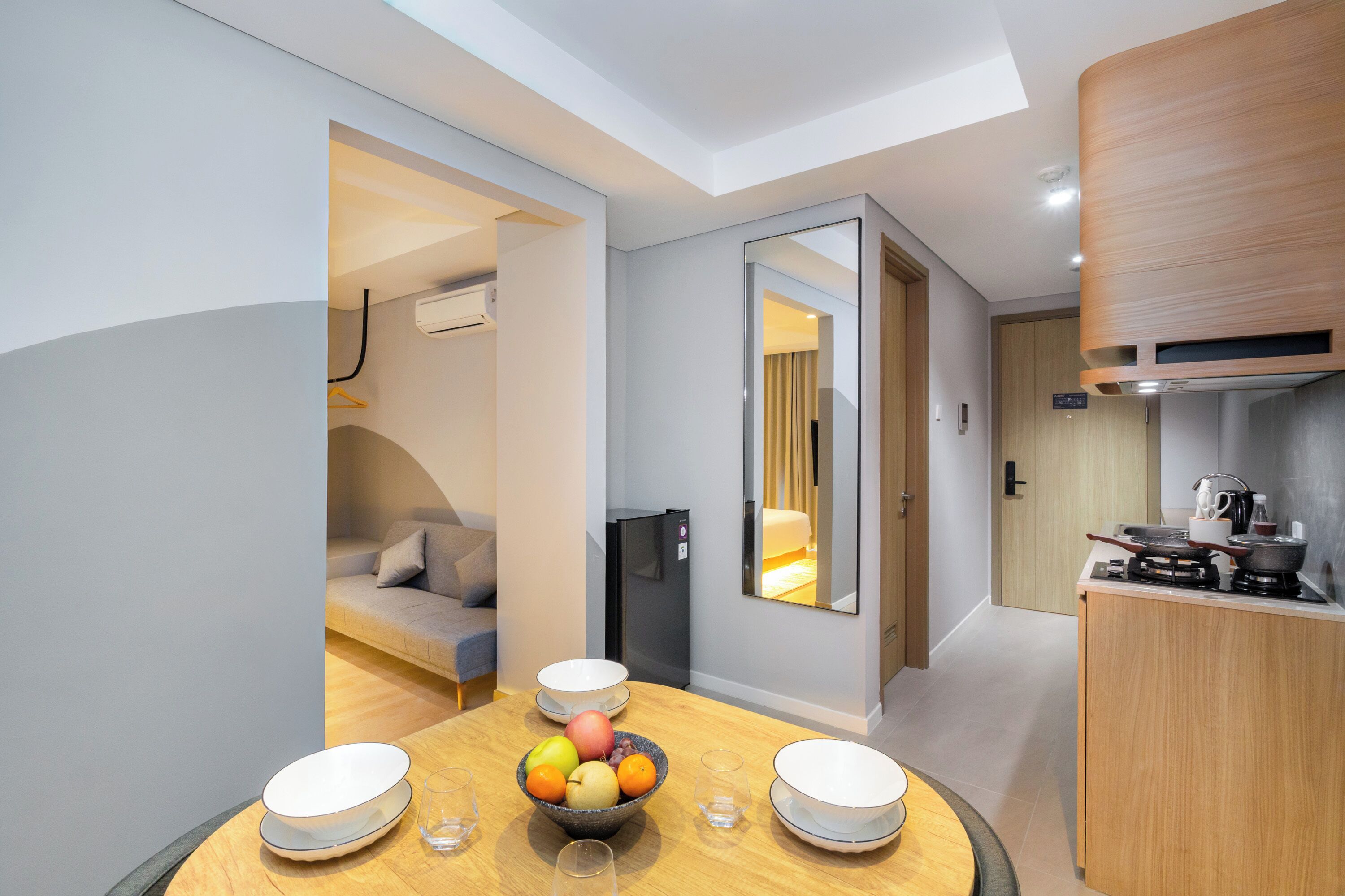 A modern kitchen with a dining area, a refrigerator, and a stove.