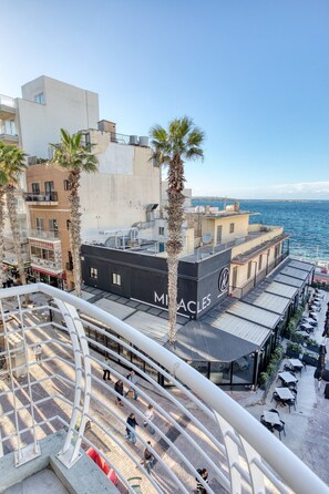 A coastal building with a rooftop bar named "Miracles."