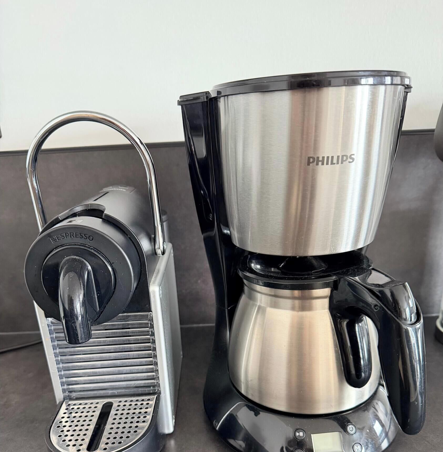 A coffee maker with a drip tray and a pot labeled "PHILIPS."