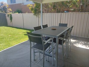 Relax in the shaded patio area with a table and six chairs.