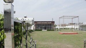 A building labeled "Hare Krishna Farm" with a grassy area in front. - Hotel Hare Krishna Vrindavan (Vrindavan)
