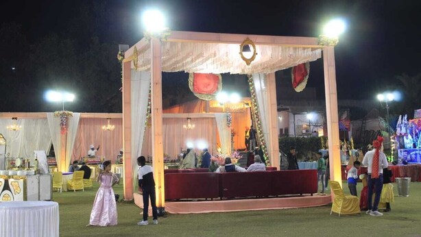An outdoor event with a decorated stage, seating, and tables. - Hotel Hare Krishna Vrindavan (Vrindavan)