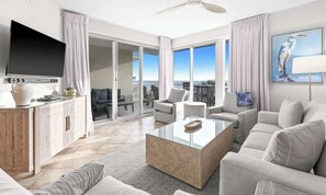 A modern living room with a flat-screen TV, a glass coffee table, and a sofa. - The Crescent 206 (Miramar beach)