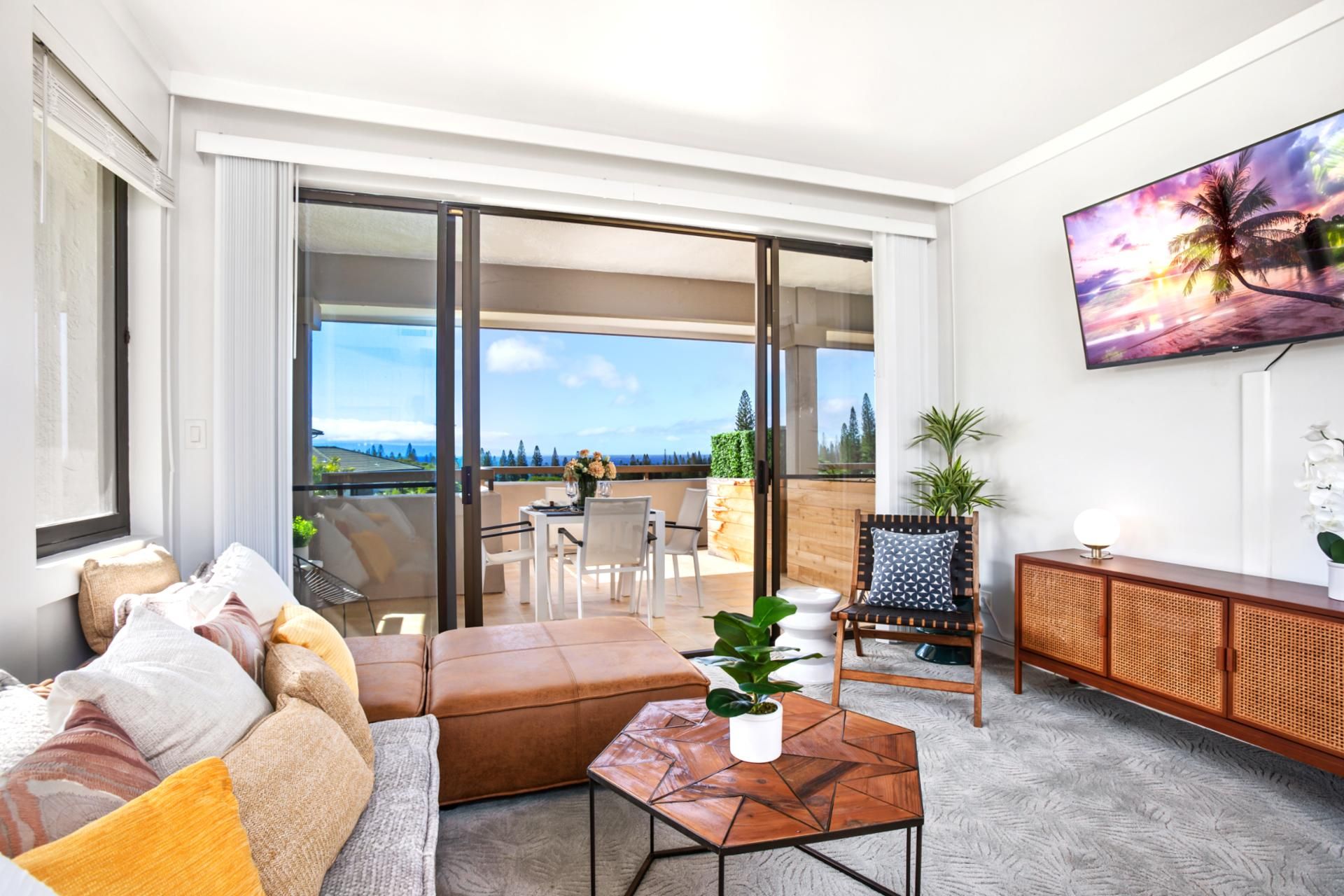 A modern living room with a sofa, coffee table, and a view of the outdoors.