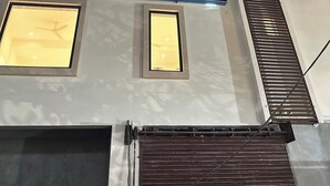 A building with multiple illuminated windows and a prominent sign for 'INNZOY HOTELS'. - Innzoy Hotels - DLF Road (Hyderabad)