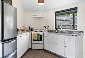 Fridge, dishwasher, cookware/dishes/utensils - The Pavilion - spacious, warm, cozy, free wifi, family friendly, outdoor living & dining (Taupō)