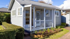 A single-story house with a porch, a garage, and a well-maintained garden.