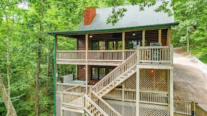 A two-story log cabin with a balcony and a staircase. - Byrdhouse On Lake Blue Ridge | Blue Ridge, GA (Blue Ridge)