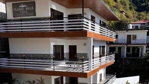 A multi-story building with a sign reading "Classic Hills Villa." It features balconies with railings and a modern architectural design. - Best hotel with Best View AC, WiFi in wonderful Mussoorie (Mussoorie)
