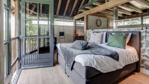 A bedroom with a bed, a window, and a view of the outdoors. - Lush holiday home with a private Hot Tub (Zeeland)
