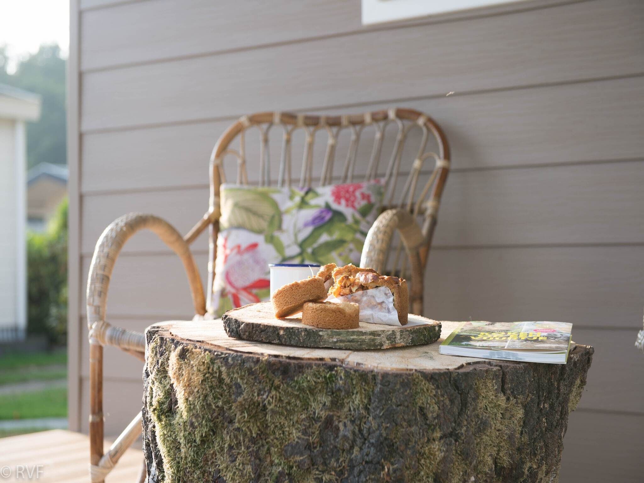 A rustic outdoor setting with a wooden chair and a table.
