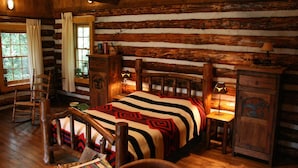 A log cabin room with a bed, wooden furniture, and a window. - Holiday Home with Garden in Den Ham (Den ham)