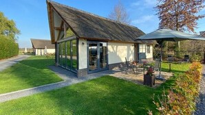 A modern house with a sloped roof and large glass windows. - Classy Holiday Home in Alphen with Garden (Alphen)