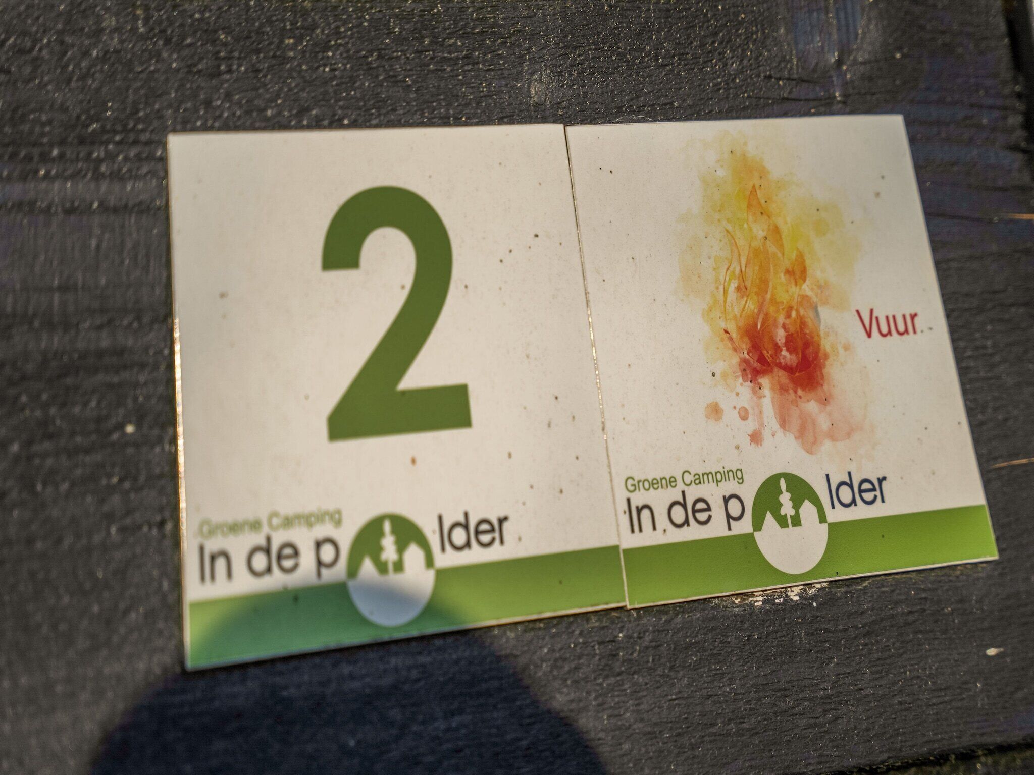 A card with the number 2 and text 'Groene Camping In de polder' and 'Groene Camping In de polder'.