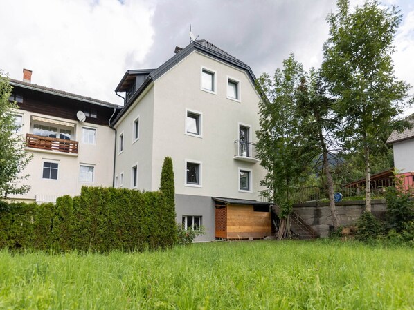 Un immeuble résidentiel à plusieurs étages, doté d’un toit plat, de nombreuses fenêtres et d’un balcon bien visible.