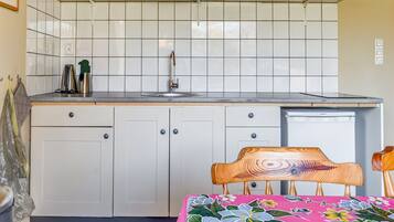 Fridge, stovetop, electric kettle, dining tables