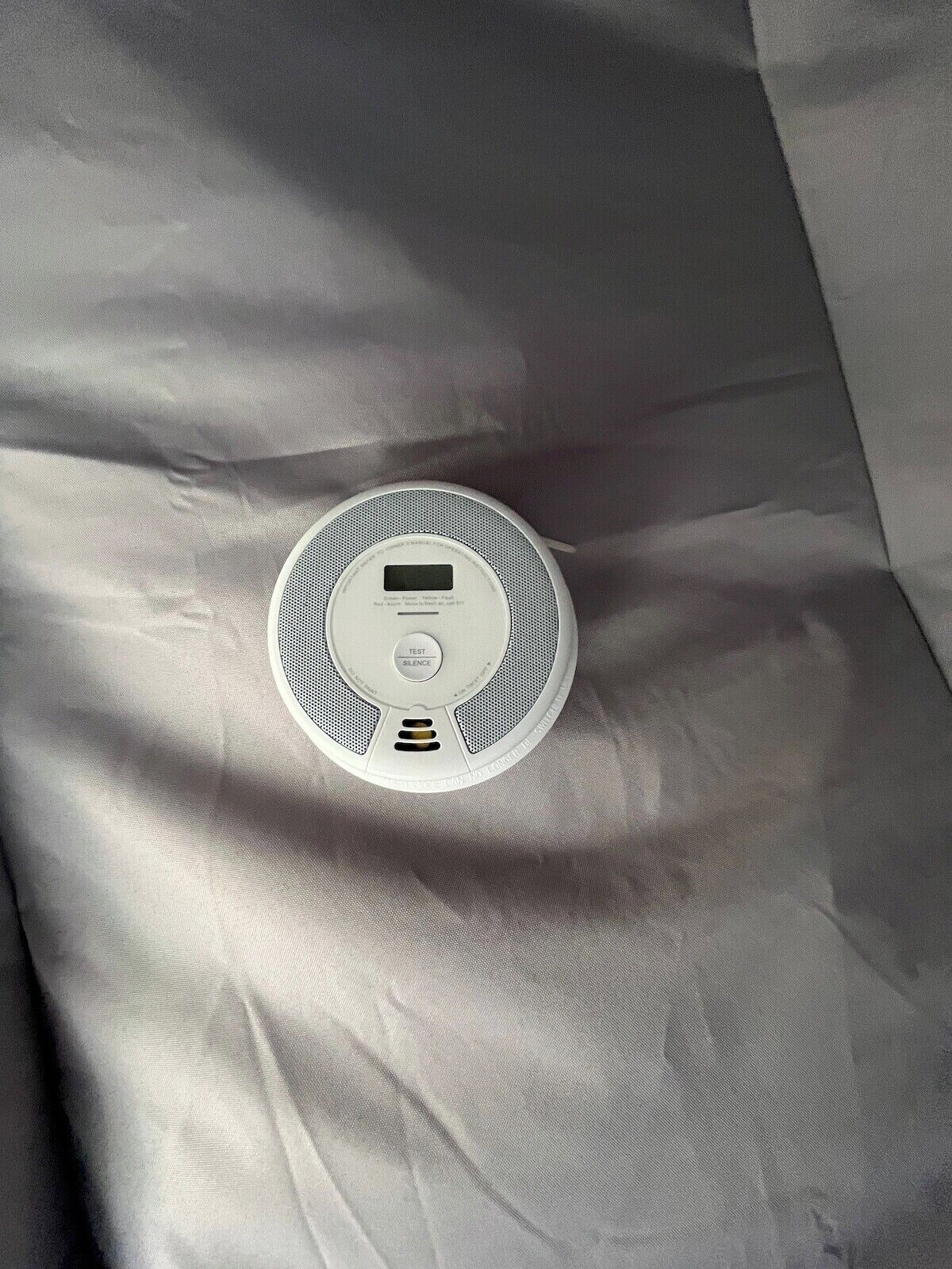 A white, circular device on a textured fabric surface.