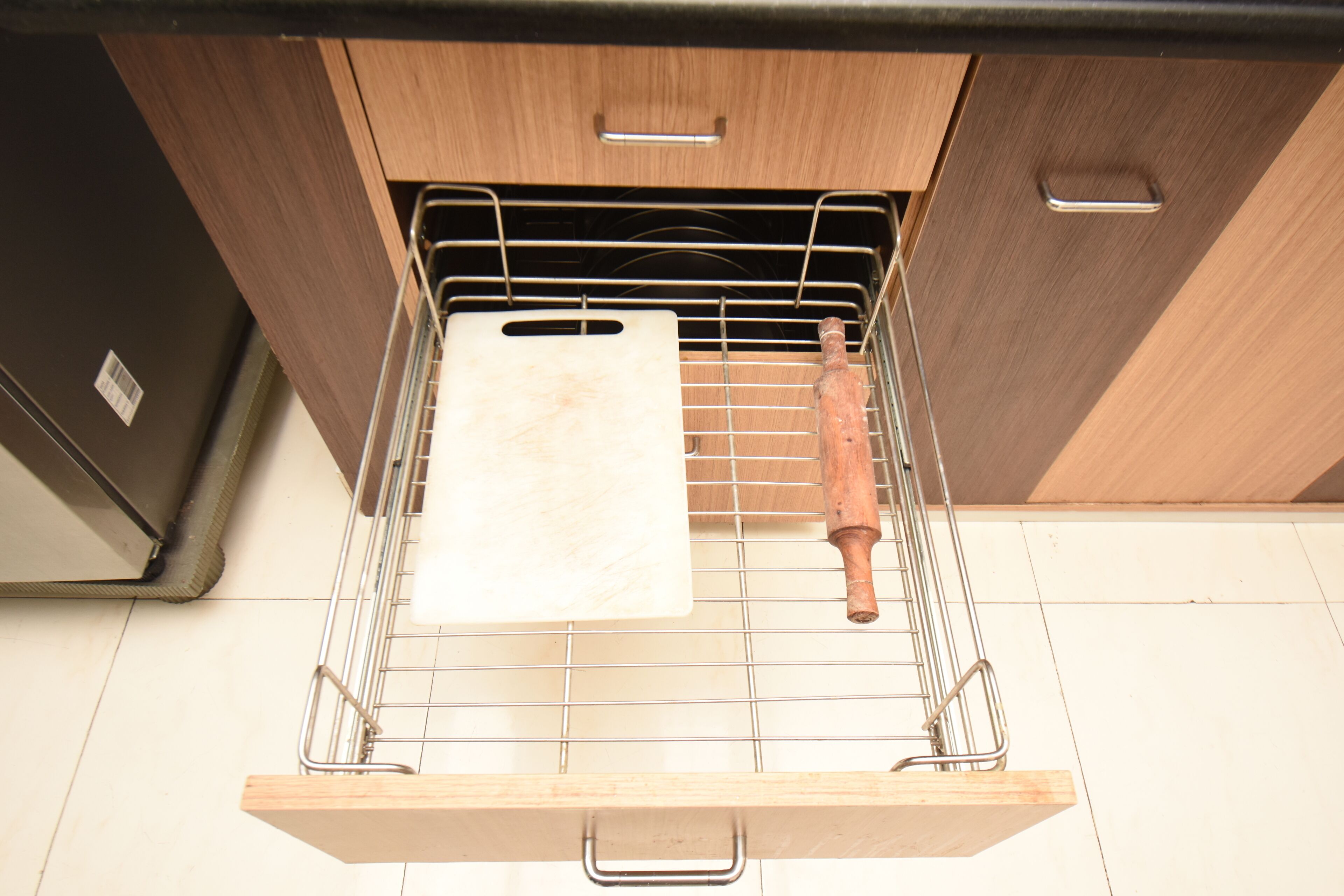 A kitchen with a wooden countertop, a metal rack, and a wooden rolling pin.