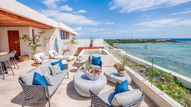 A rooftop terrace with a pool, lounge chairs, and a view of the ocean. - Tulum Beachfront Penthouse – Rooftop & Pool (Tulum)