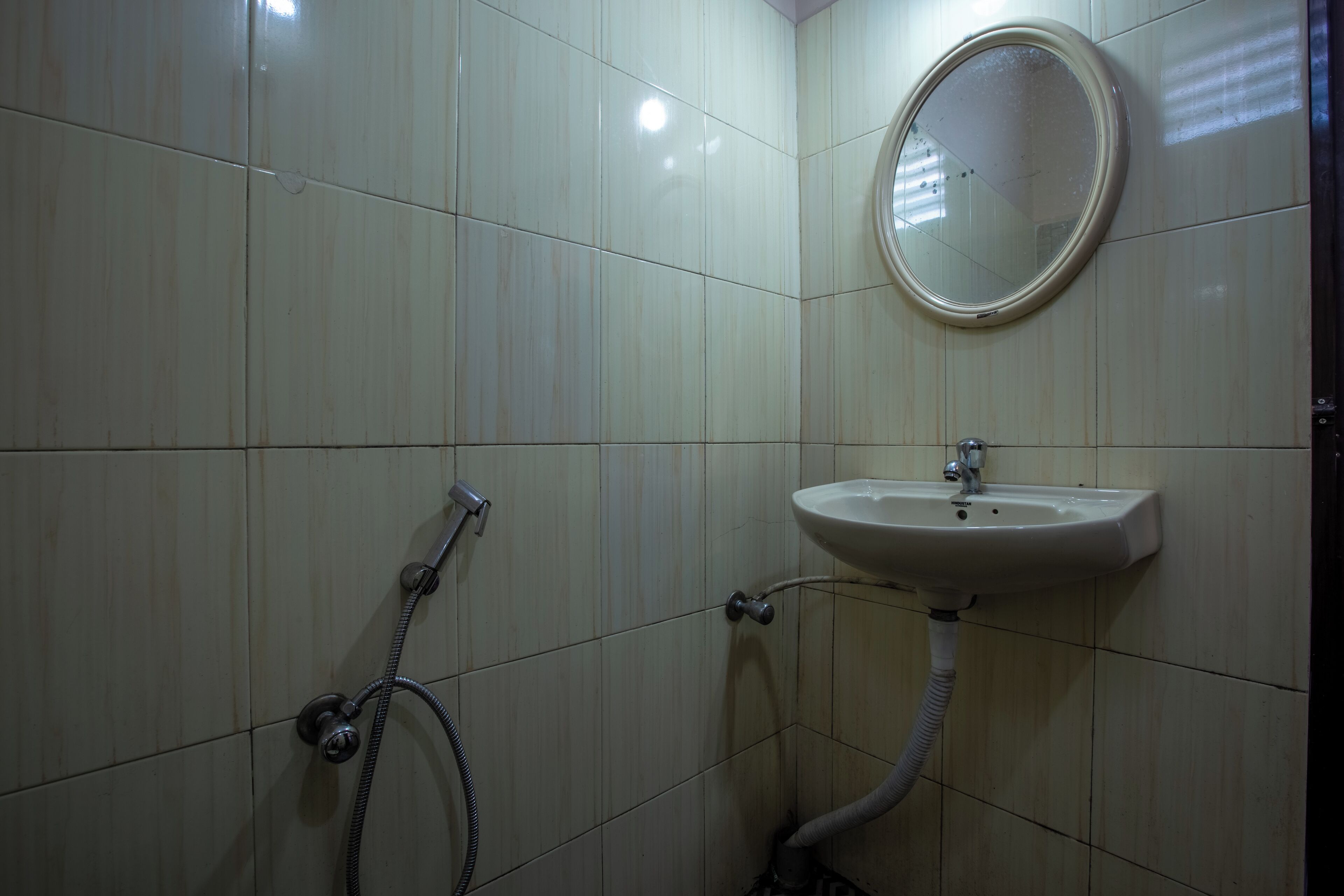A bathroom with a sink, mirror, and shower.