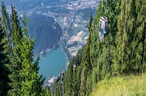 A cable car system with a view of a lake and surrounding landscape.