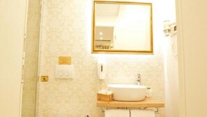 A bathroom with a toilet, sink, and mirror. - Villa madonna della Strada A5 (Dubrovnik)