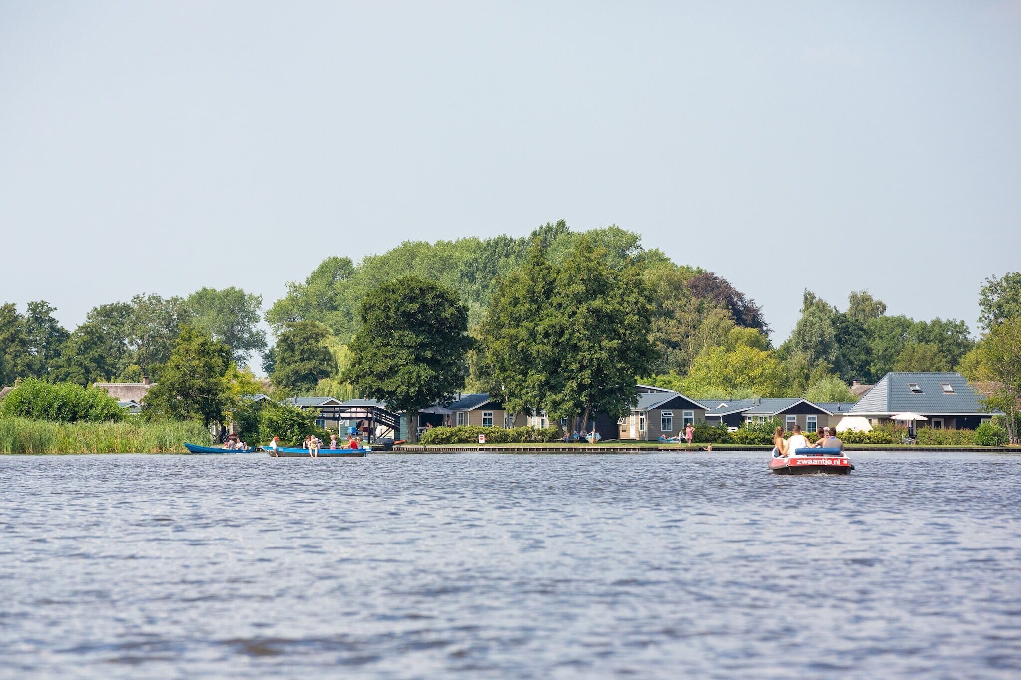 A lakeside view with houses and a boat dock.