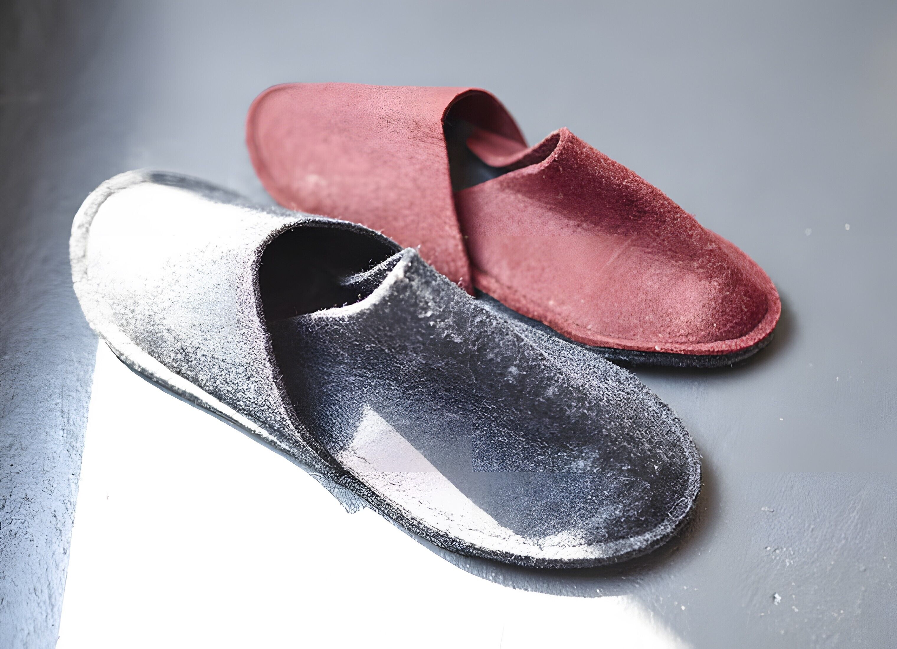 A pair of slippers on a reflective surface.