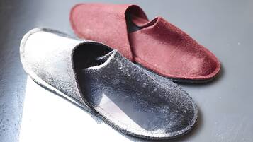 A pair of slippers on a reflective surface.
