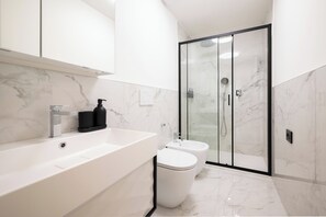 Een douche, een haardroger, een bidet, handdoeken