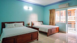 A room with two wooden beds, a ceiling fan, and a window with curtains. - Minh Hanh Hotel Sam Son -BAY LUXURY (Sam Son)
