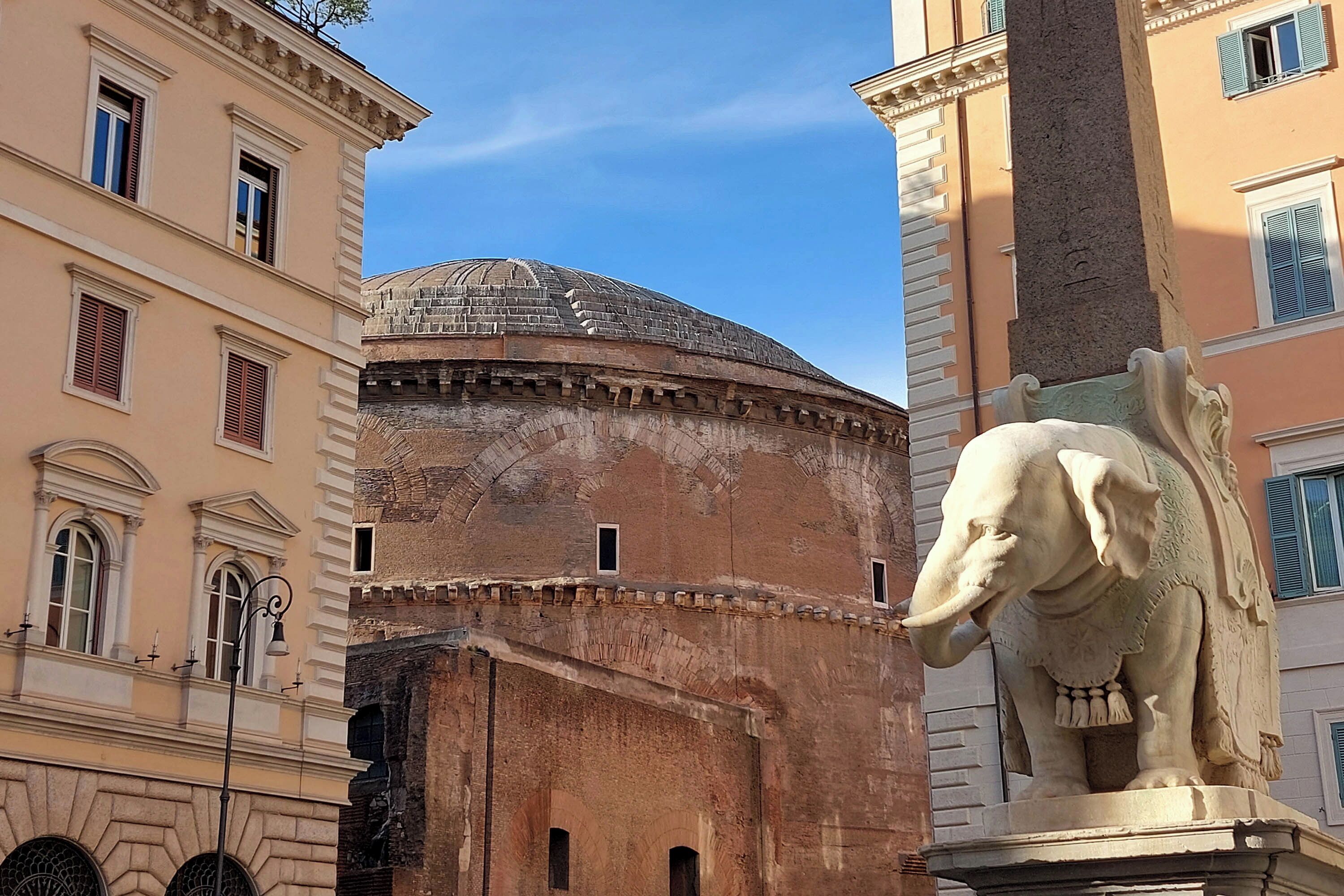 A historic building with a dome and a statue of an elephant.