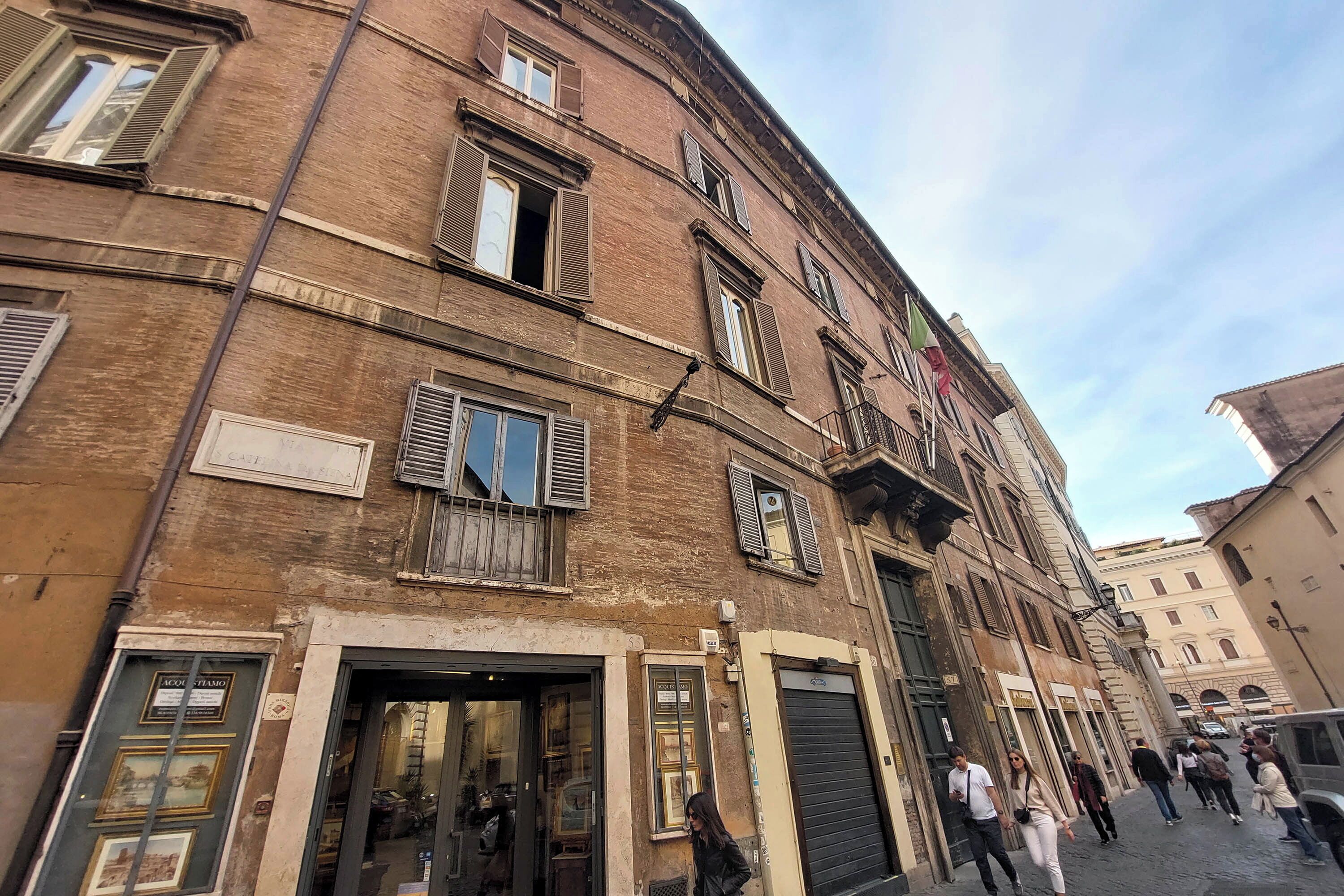 Een historisch gebouw met veel ramen en een etalage.