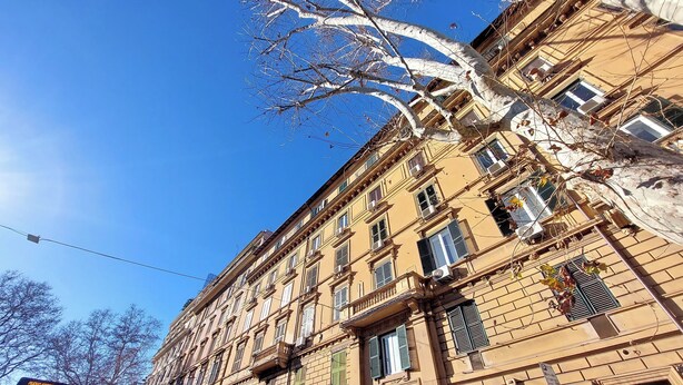 A multi-story building with a classic architectural style, featuring numerous windows and balconies. - Borghese Park View (Rome)