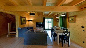 A cozy cabin interior with a living area, dining space, and a staircase. - Cozy home in Czaplinek with lake view (Czaplinek)