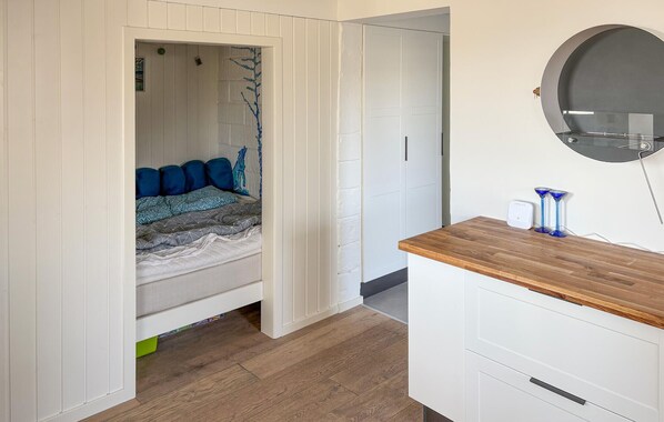A bedroom with a bed, a bedside table, a mirror, and a wardrobe. - Beautiful home in Haderslev with sauna (Haderslev)