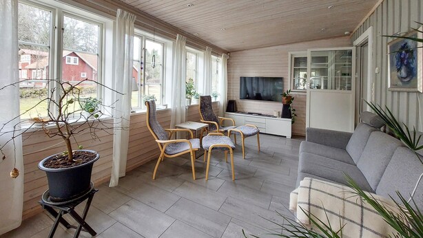 A cozy living room with a sofa, two armchairs, a TV, and a dining table. - Amazing home in ör with WiFi (Ör)