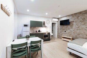 Classic Studio, Balcony | Living area | 43-inch flat-screen TV with digital channels