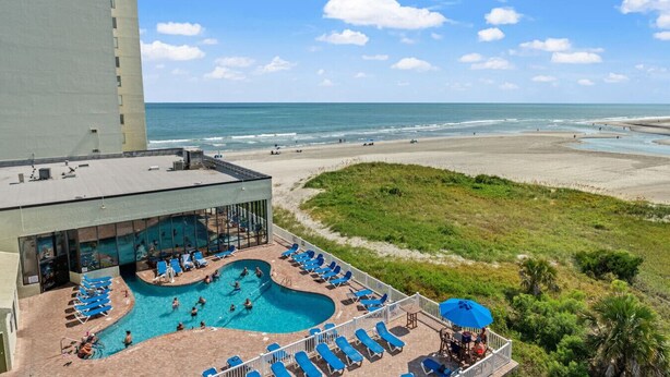 A hotel with a swimming pool, beach view, and a building labeled "Sands Beach Club". - Oceanfront Resort 2Br Condo Pools and Hot Tubs (Myrtle Beach)